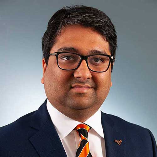 a man wearing glasses and a suit and tie