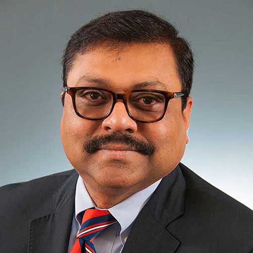 a man wearing glasses and a suit and tie