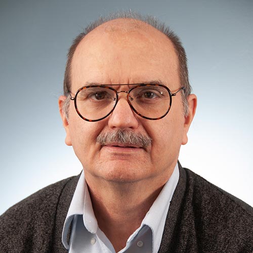 a man wearing glasses and looking at the camera