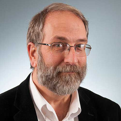 a man wearing glasses and looking at the camera