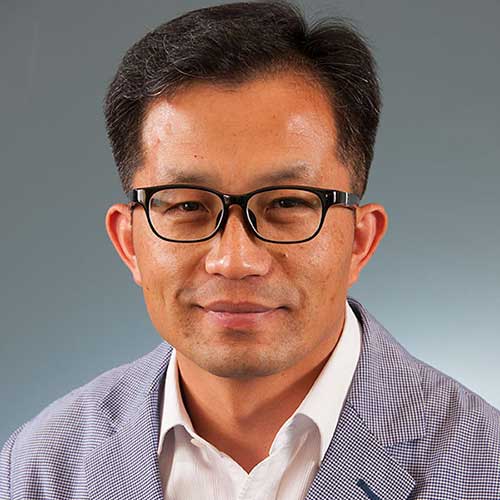 a man wearing glasses posing for the camera