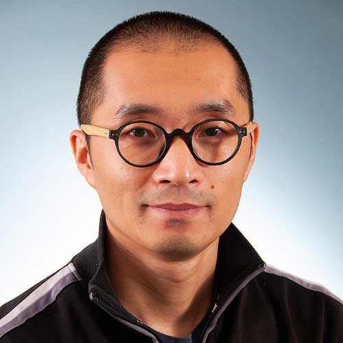 a man wearing glasses and looking at the camera