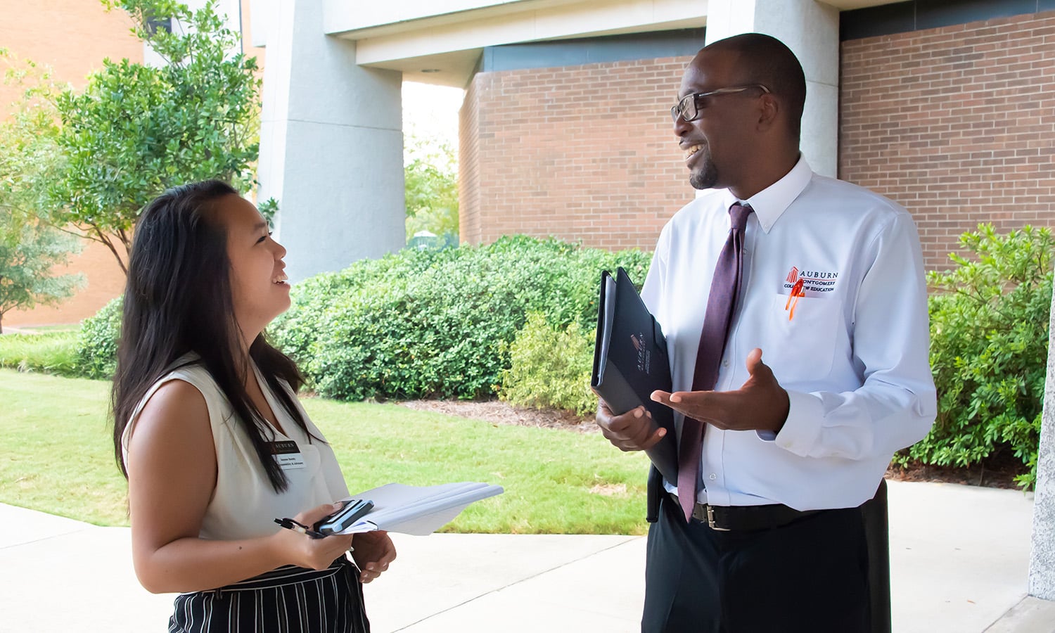 a man and a woman standing in front of a building