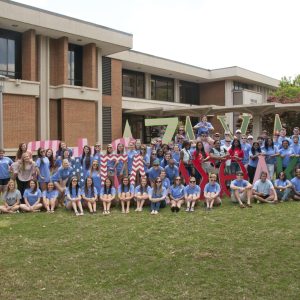 A Group Of People Standing In Front Of A Building