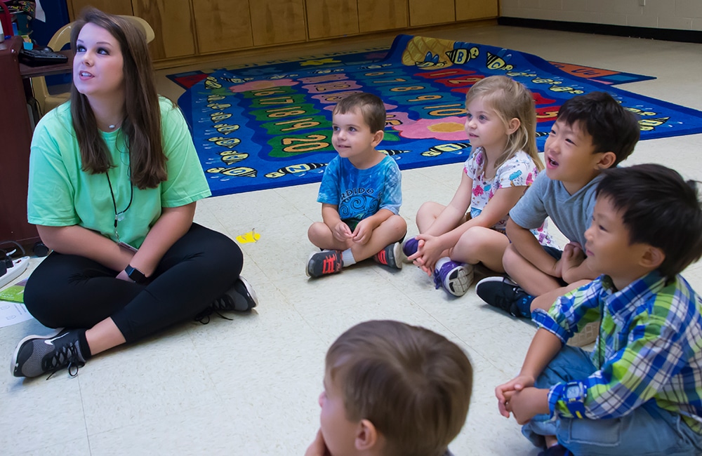a group of young children sitting on a table