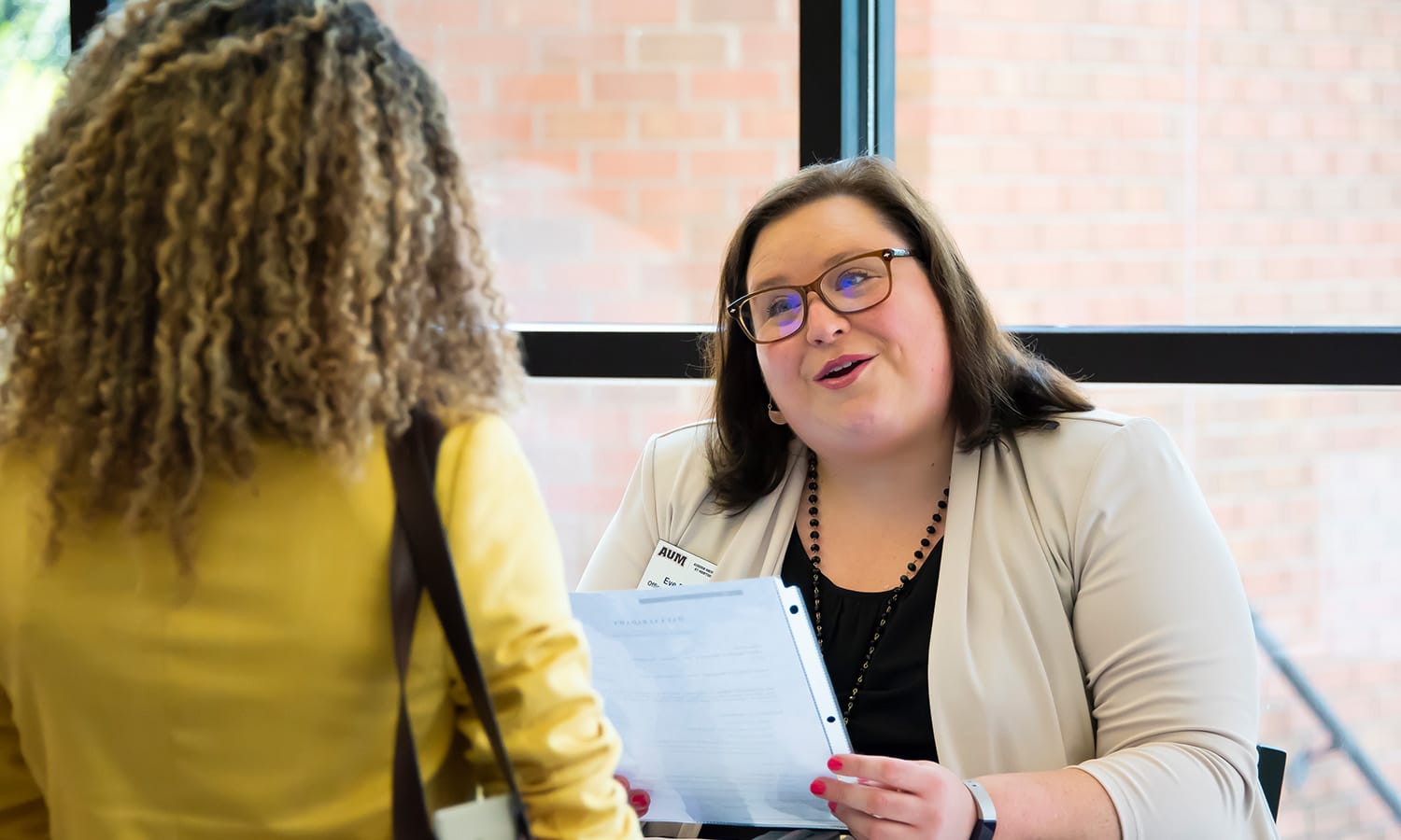 a woman standing in front of a window