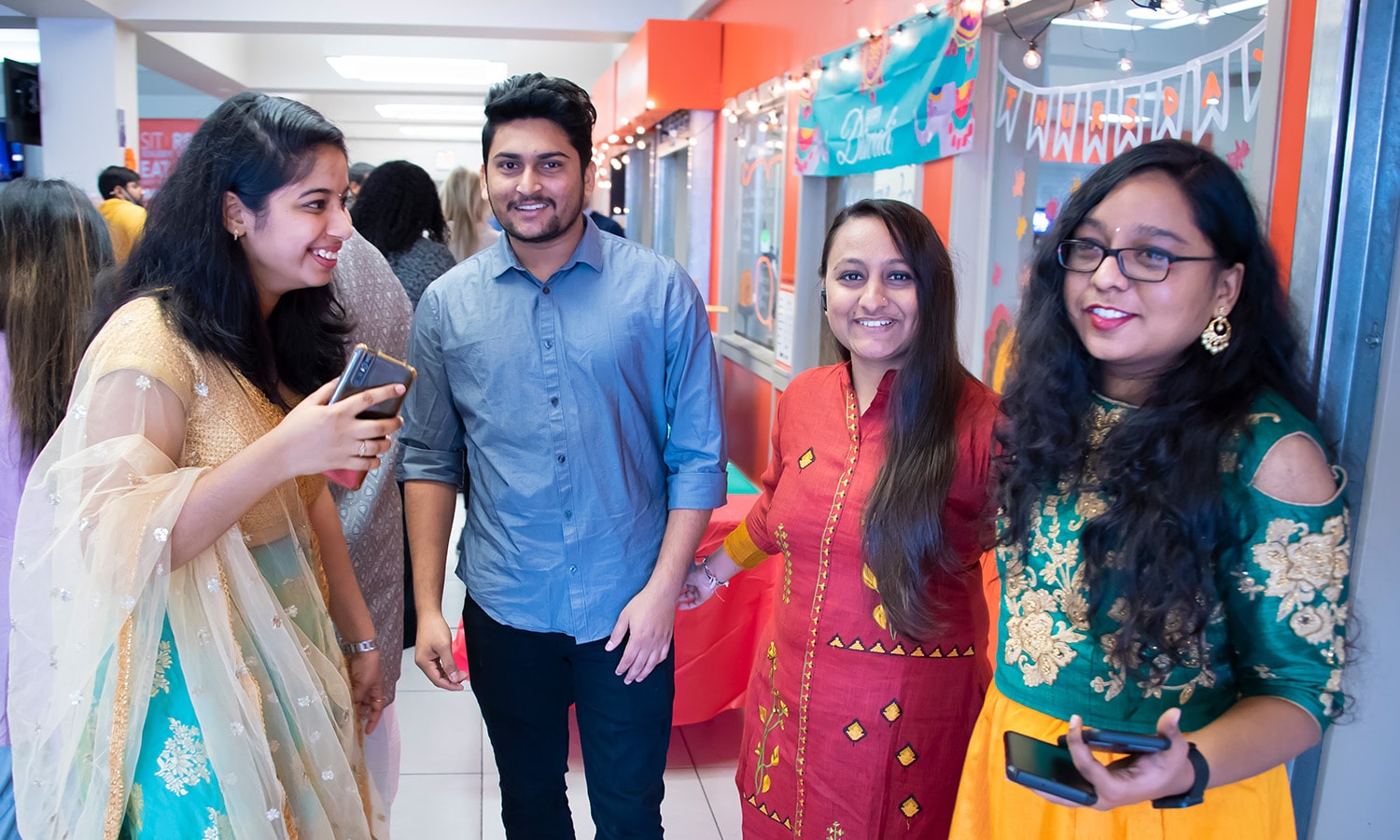a person standing in front of a group of people posing for the camera