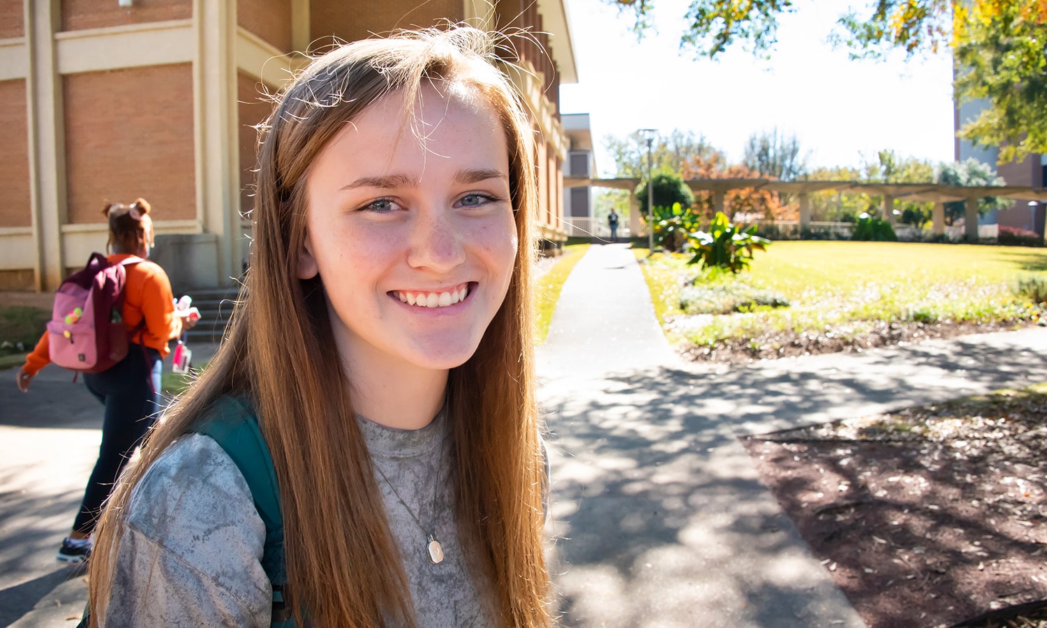 a woman wearing a hat and smiling at the camera a woman wearing a hat and smiling at the camera