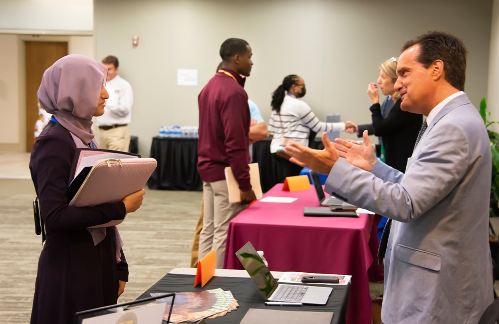 a group of people standing around a table