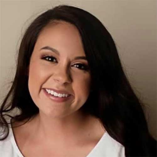 a woman smiling and posing for the camera