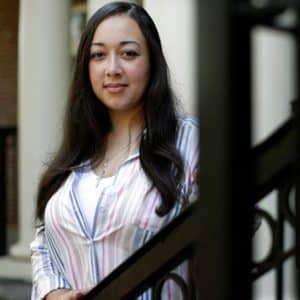 A Woman Standing In Front Of A Window