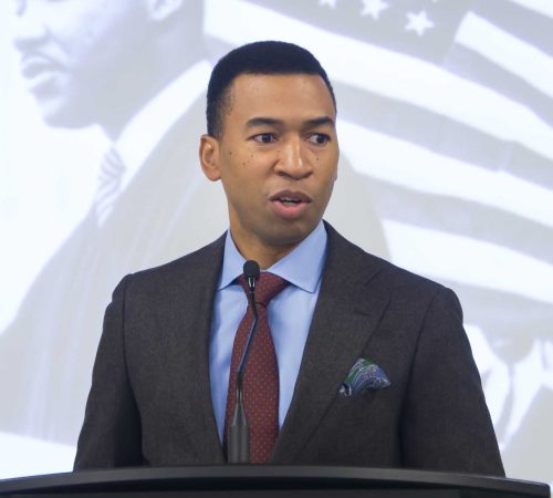 A Man Wearing A Suit And Tie