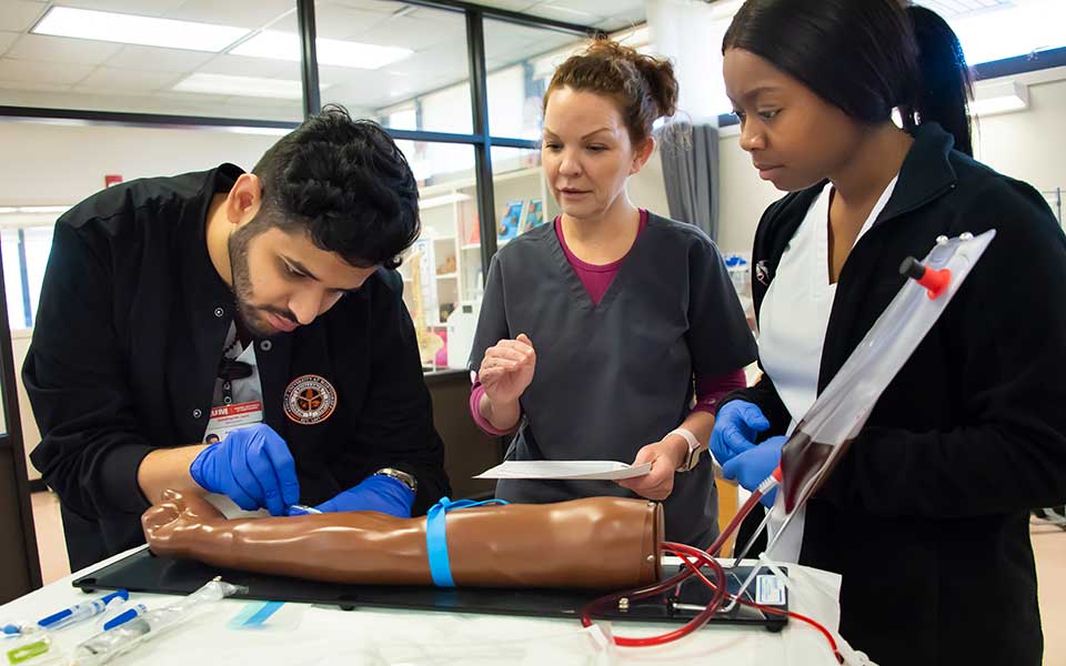 Nursing students training on an IV