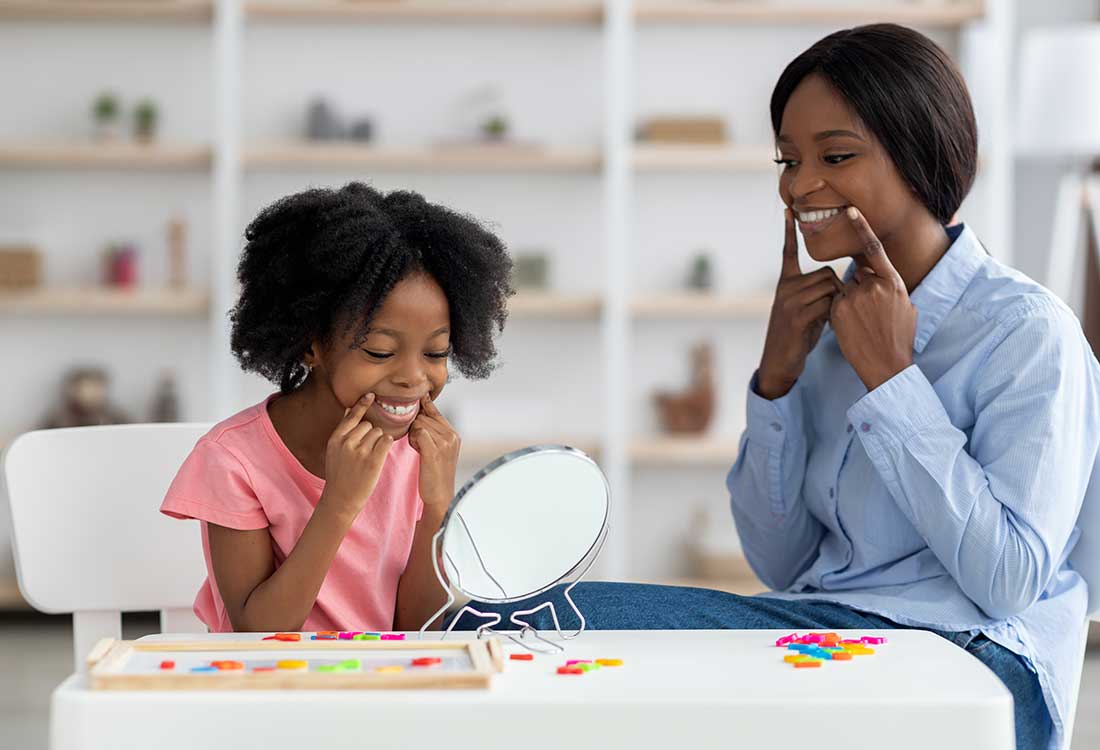 a woman sitting at a table with a cake