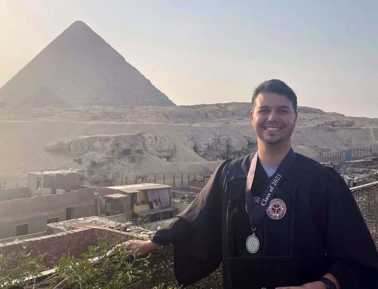 a man standing in front of a mountain