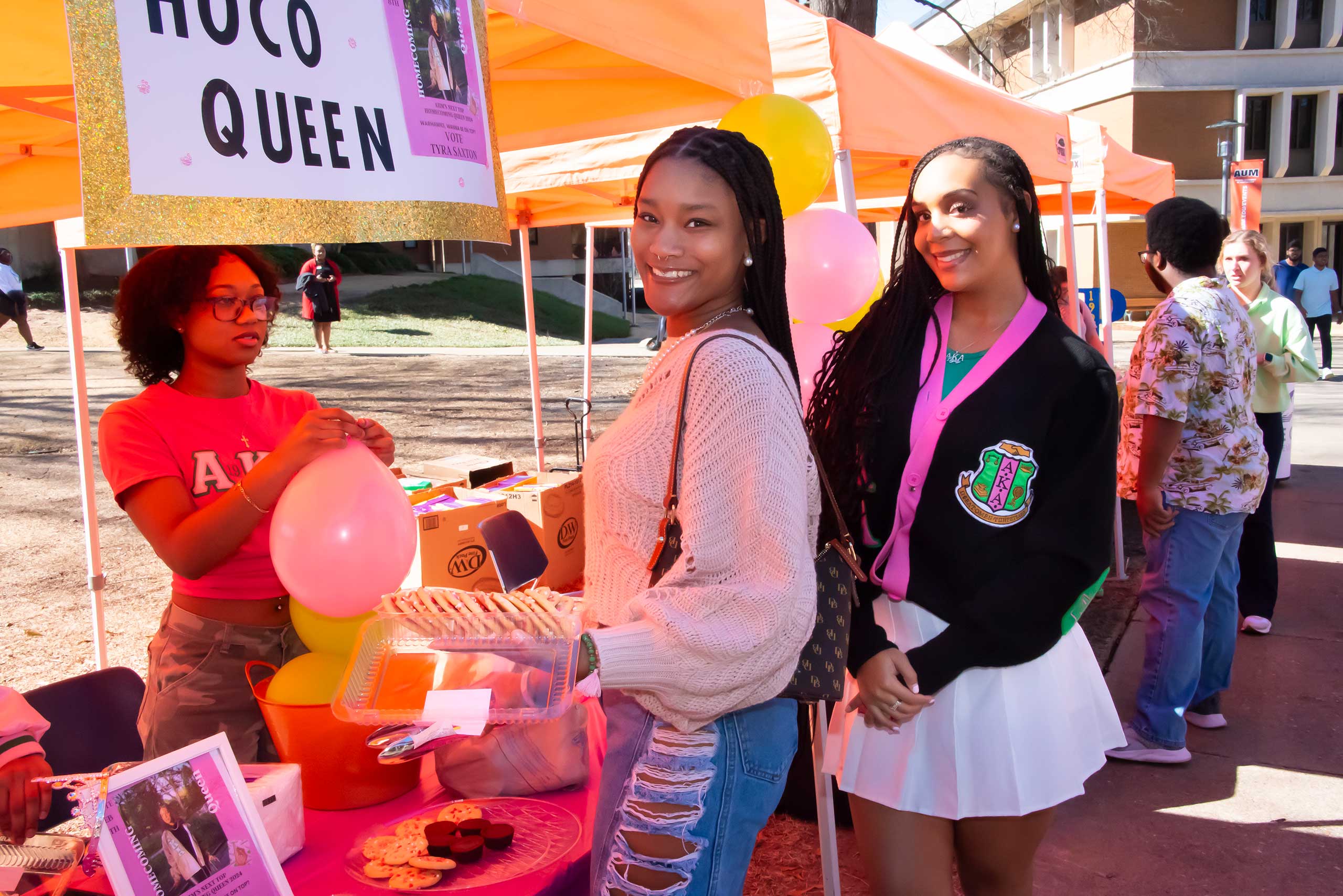 a group of people standing next to a person holding a sign