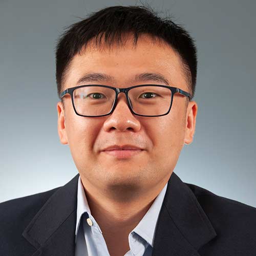 a man wearing glasses posing for the camera