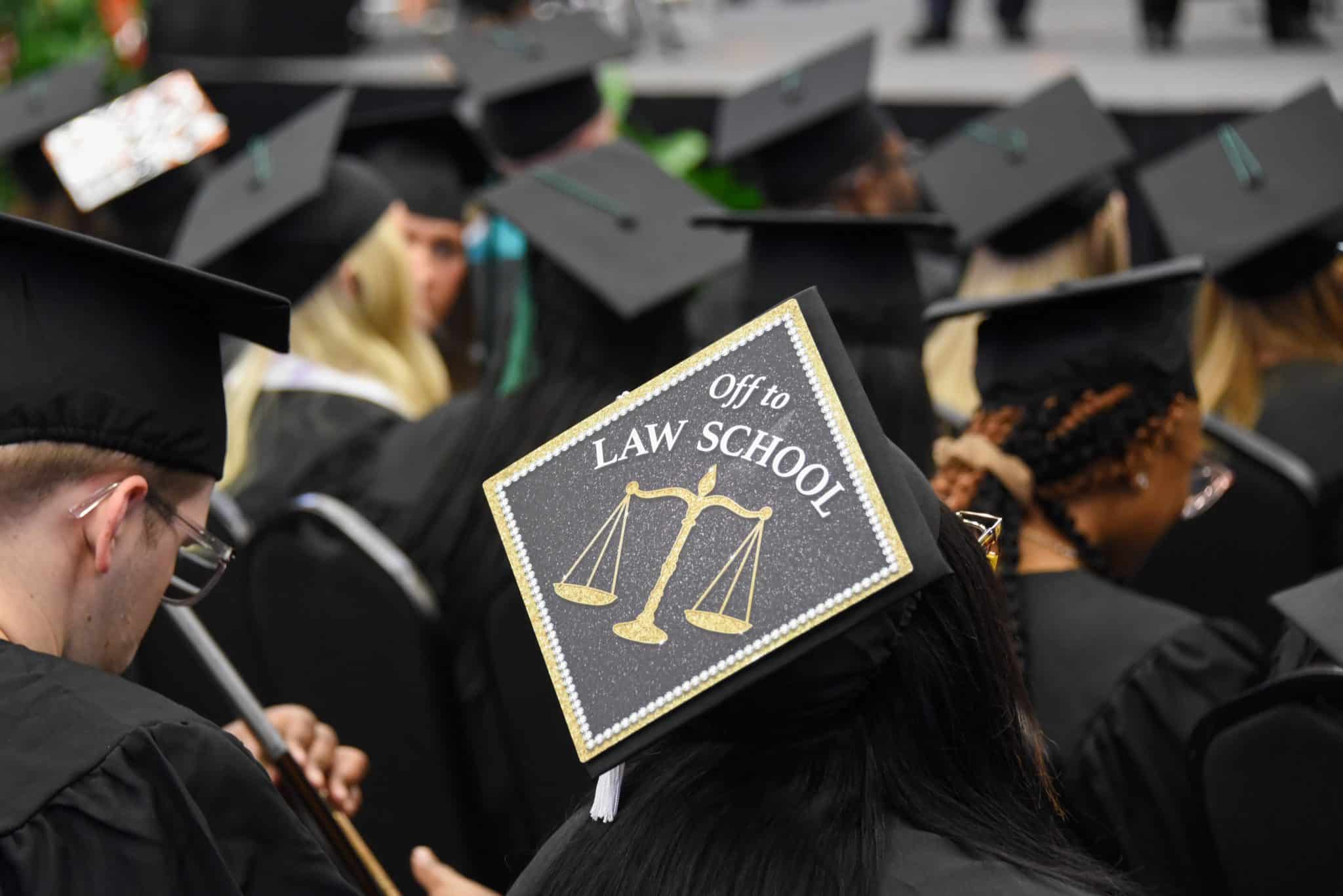 An Auburn University at Montgomery student states her future intention of attending law school on her graduation mortarboard.